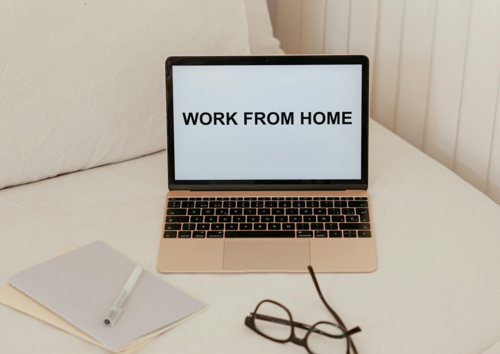 A simple work from home setup featuring a laptop on a bed. Ideal for remote work themes.